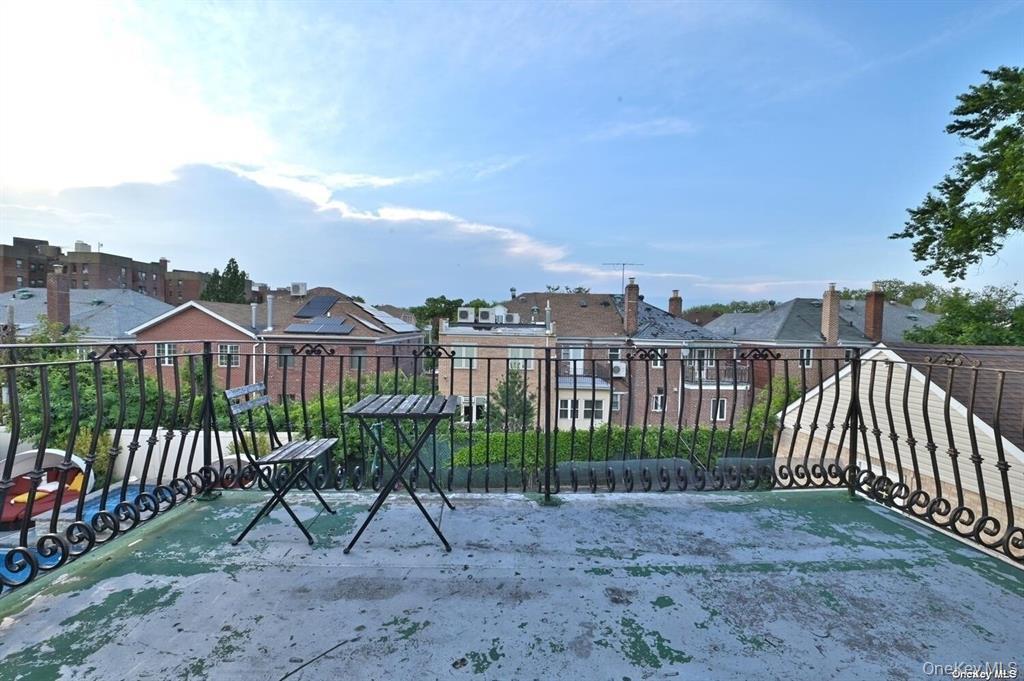 108-35 66th Road Queens, NY 11375 - Photo 18 of 19 a view of a house with a porch and furniture