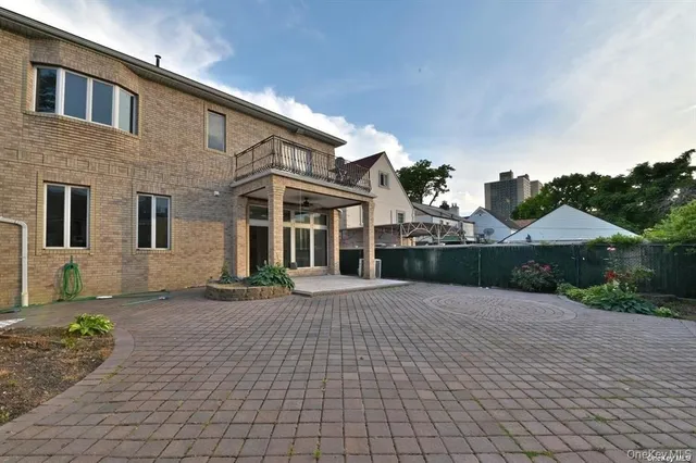 a front view of a house with a yard and potted plants