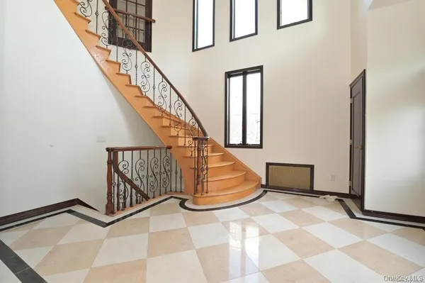 a view of entryway with stairs and wooden floor