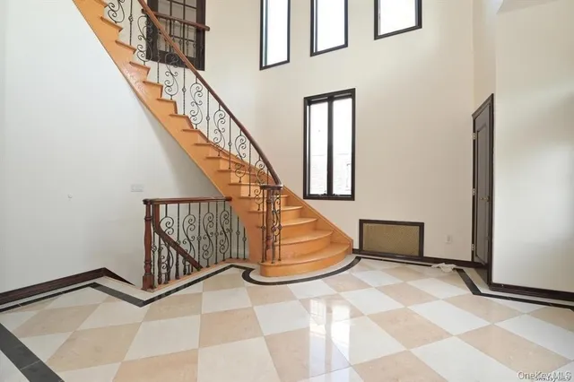 a view of entryway with stairs and wooden floor