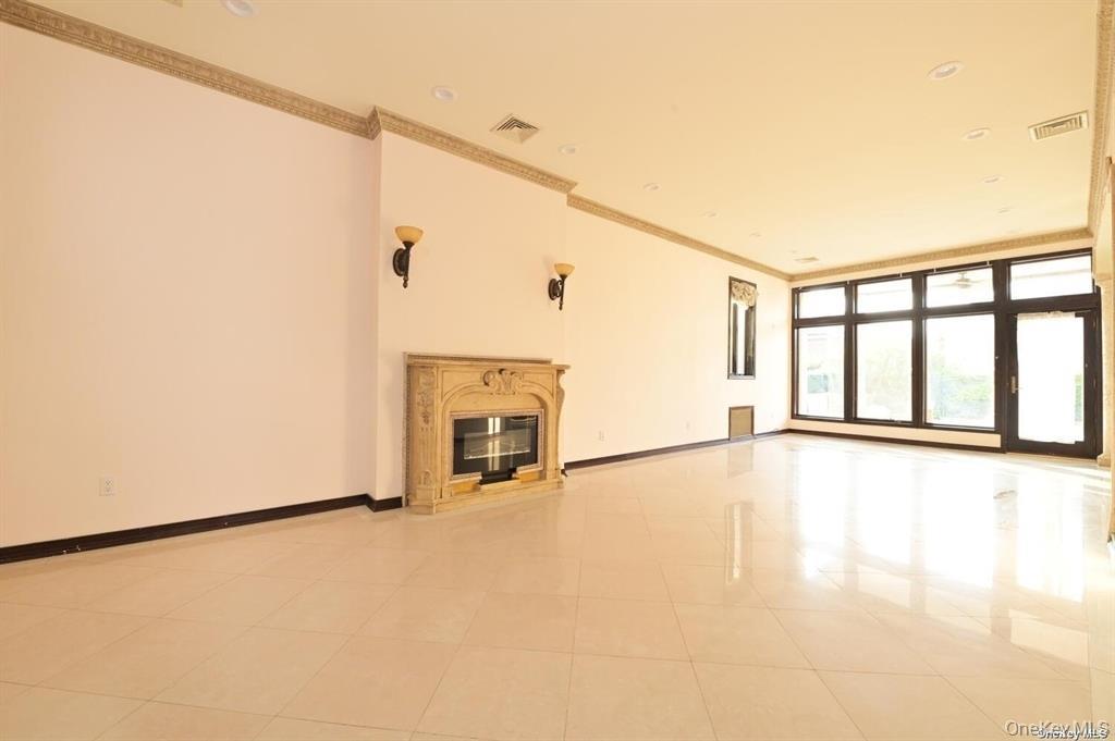 108-35 66th Road Queens, NY 11375 - Photo 6 of 19 a view of an empty room with chandelier fan and a window