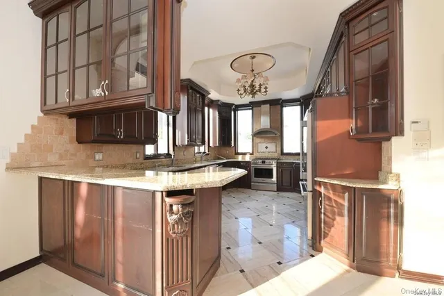 a kitchen with stainless steel appliances granite countertop a refrigerator sink and stove