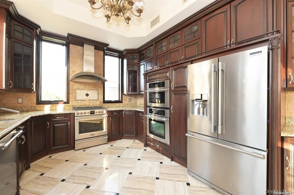 108-35 66th Road Queens, NY 11375 - Photo 9 of 19 a kitchen with stainless steel appliances granite countertop a refrigerator sink and stove