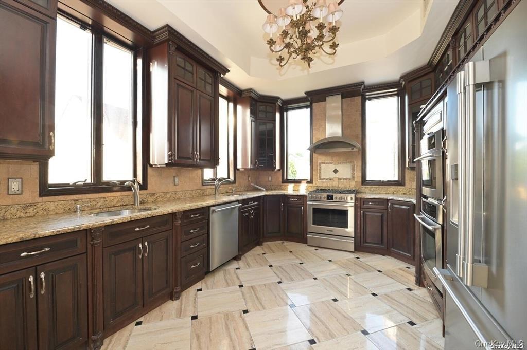 108-35 66th Road Queens, NY 11375 - Photo 10 of 19 a large kitchen with a large window and stainless steel appliances