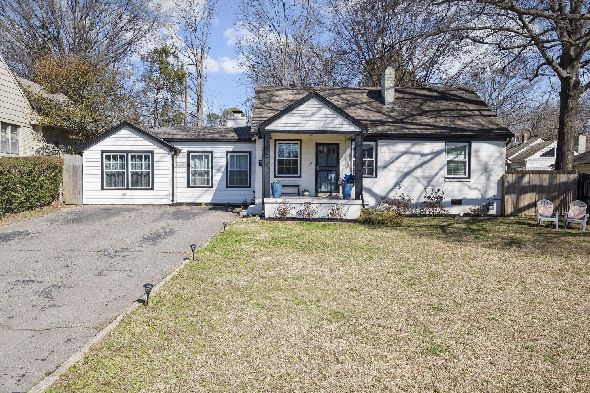 4120 Village Road Memphis, TN 38117 - Photo 2 of 28 View of front of house with covered porch, a chimney, asphalt driveway, and a shingled roof