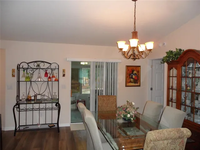 a living room with furniture a flat screen tv and kitchen view