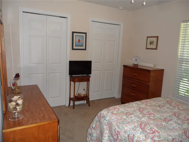 a bedroom with a bed and cupboard
