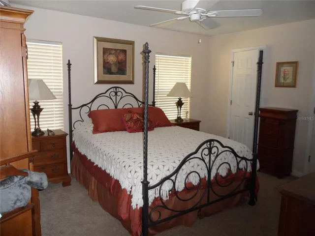 a bedroom with a bed next to a window