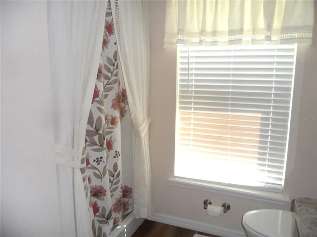 a living room with furniture and floor to ceiling windows
