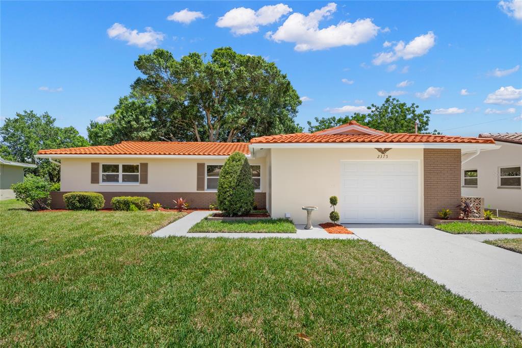 2375 Rutland Lane Clearwater, FL 33763 - Photo 1 of 1 a backyard of a house with table and chairs