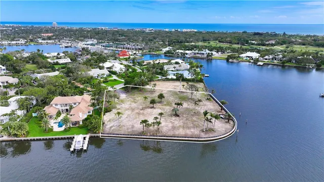 an aerial view of a house with a lake view