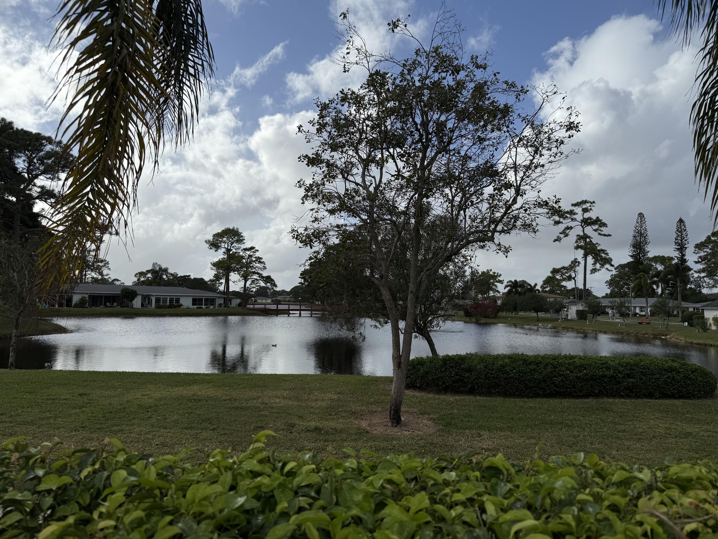 5139 Poppy Place, Unit A Delray Beach, FL 33484 - Photo 12 of 36 a view of a lake from a yard