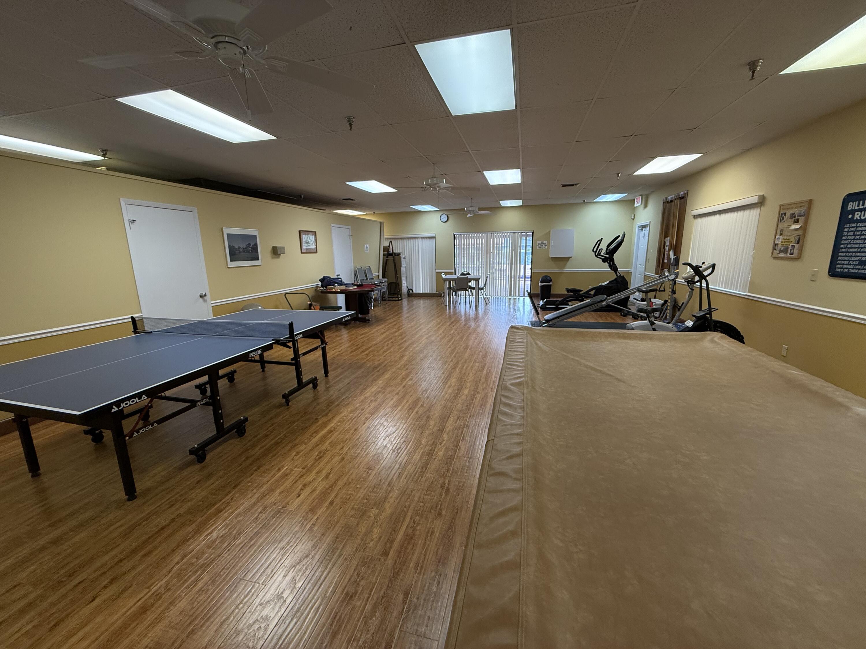 5139 Poppy Place, Unit A Delray Beach, FL 33484 - Photo 14 of 36 a view of a room with gym equipment and a table