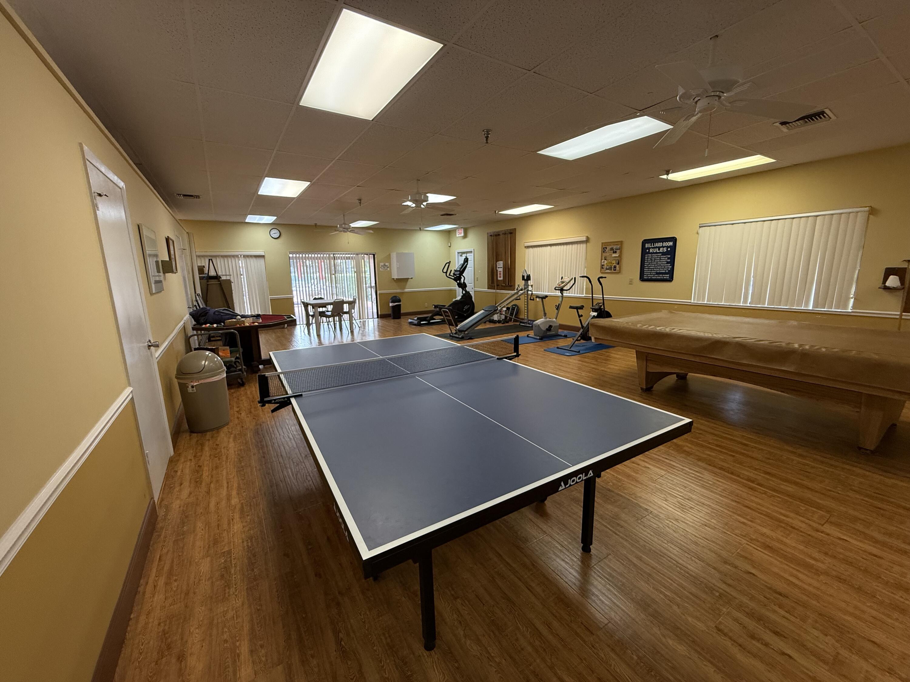 5139 Poppy Place, Unit A Delray Beach, FL 33484 - Photo 15 of 36 a room with lots of counter space and wooden floor