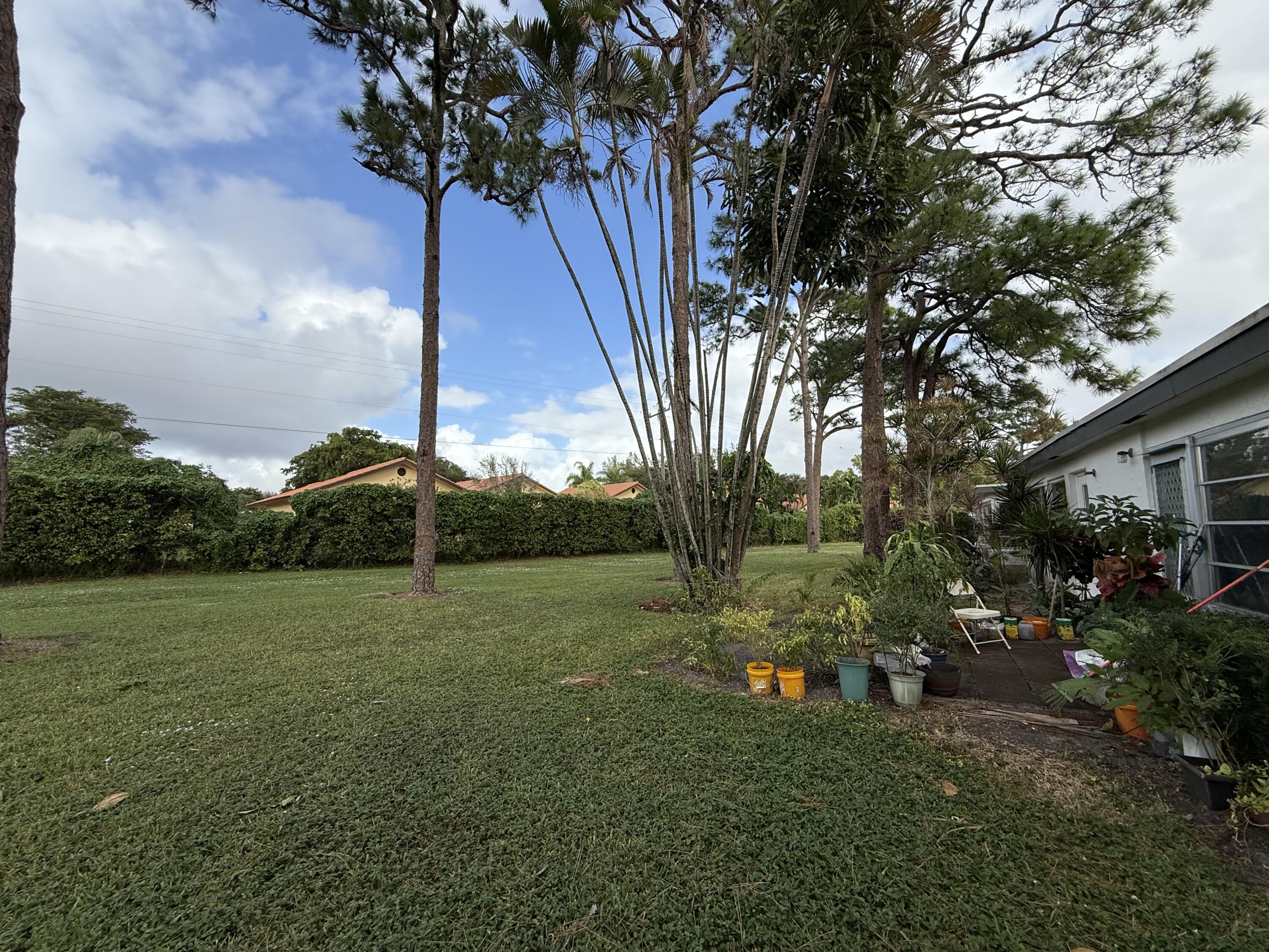 5139 Poppy Place, Unit A Delray Beach, FL 33484 - Photo 20 of 36 a view of a field with a tree