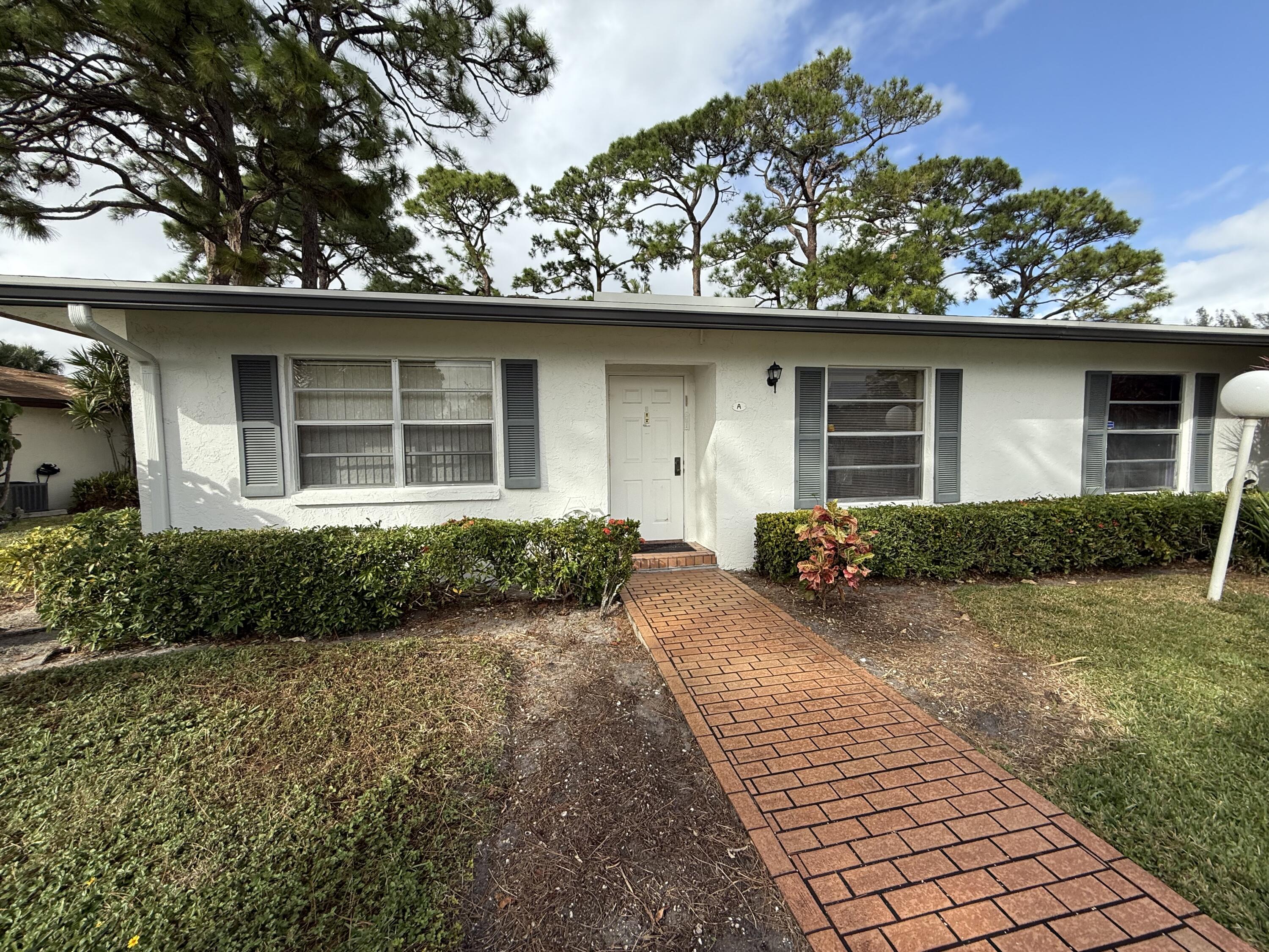 5139 Poppy Place, Unit A Delray Beach, FL 33484 - Photo 2 of 36 front view of a house with a yard