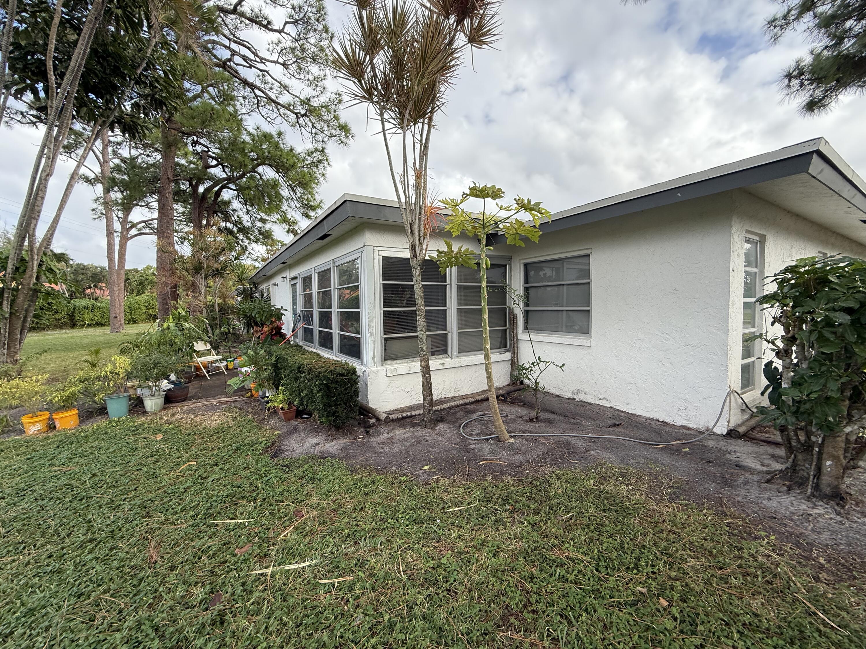 5139 Poppy Place, Unit A Delray Beach, FL 33484 - Photo 21 of 36 a view of a house with a yard