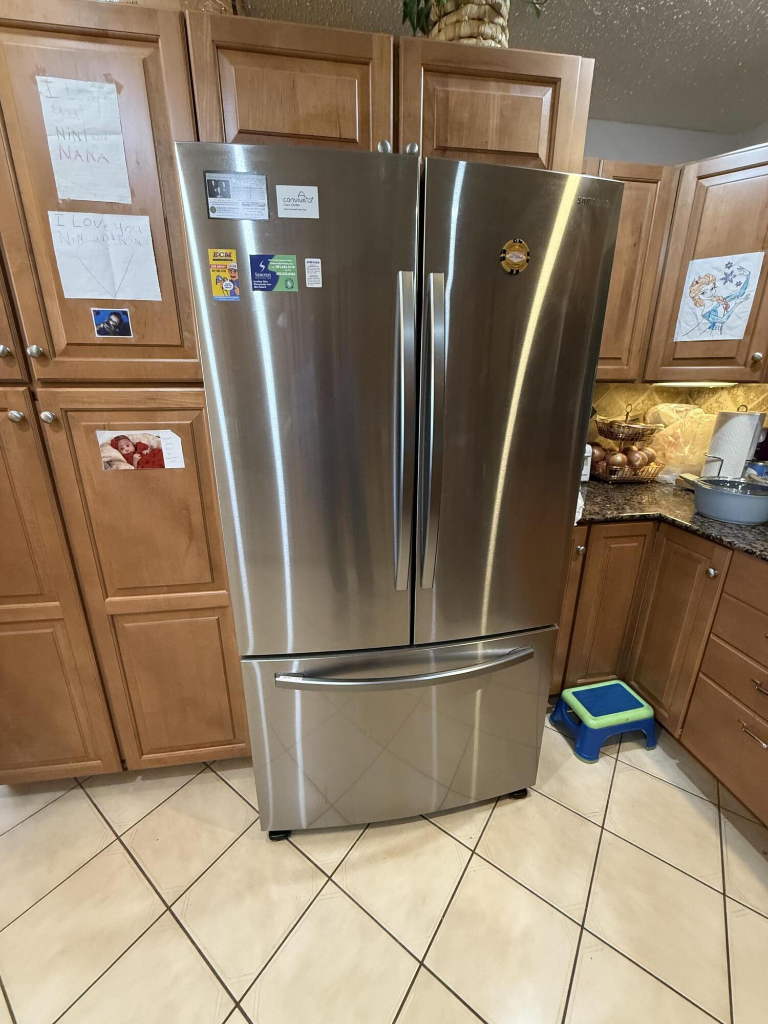 5139 Poppy Place, Unit A Delray Beach, FL 33484 - Photo 24 of 36 a view of a refrigerator with wooden floor and cabinet