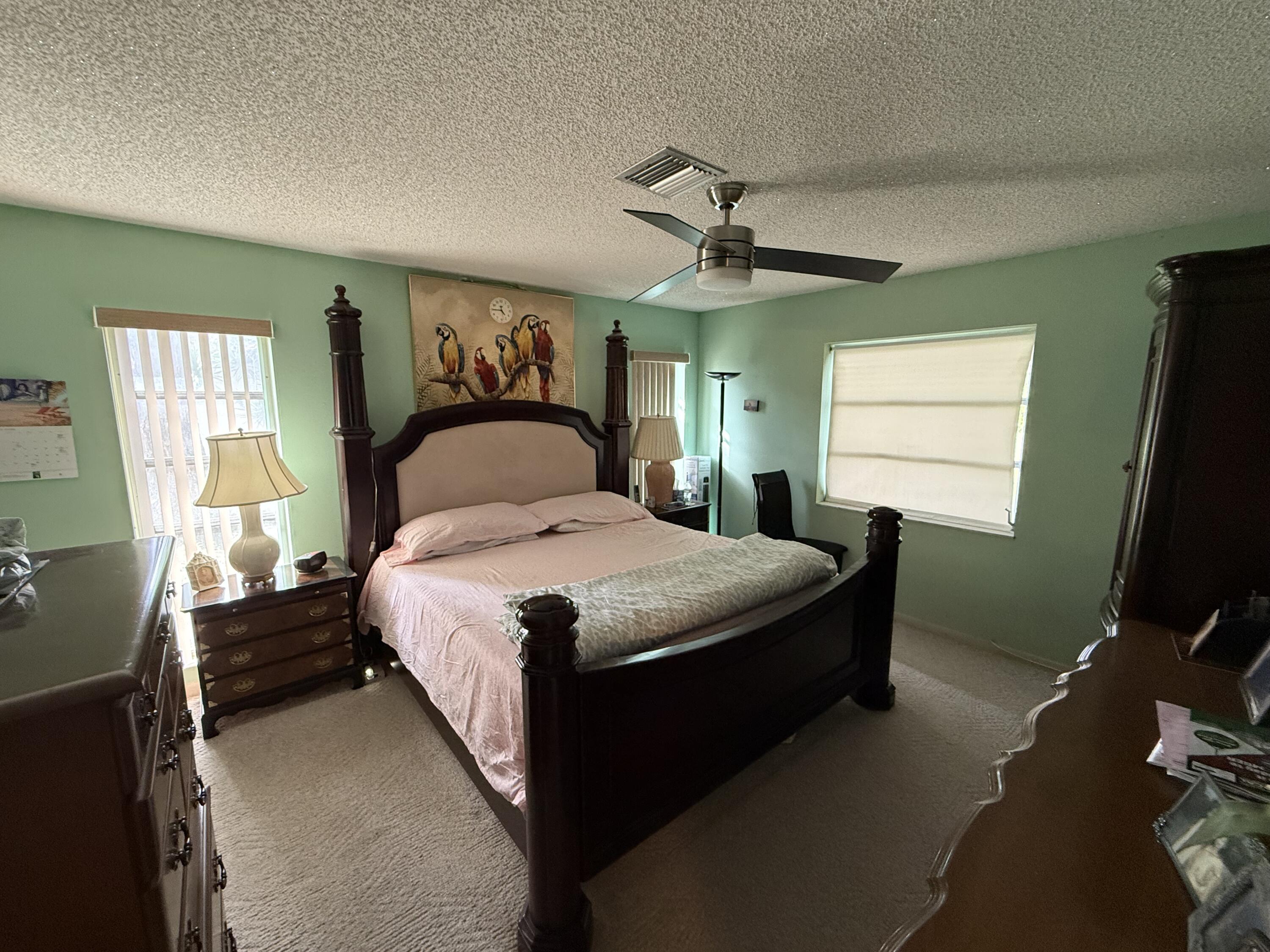 5139 Poppy Place, Unit A Delray Beach, FL 33484 - Photo 35 of 36 a bedroom with a bed and window