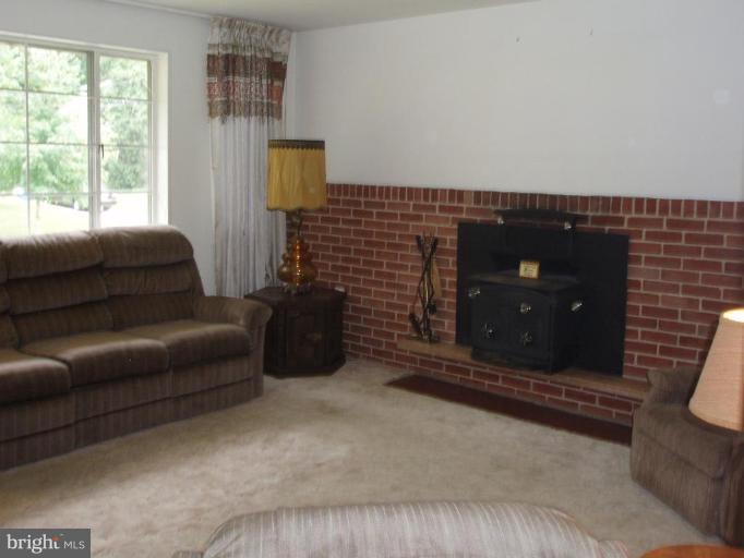 9718 Holmhurst Road Bethesda, MD 20817 - Photo 3 of 12 Fireplace with wood stove insert