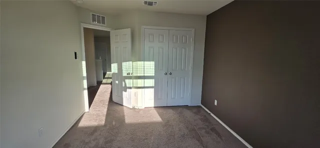 a view of an empty room and a window