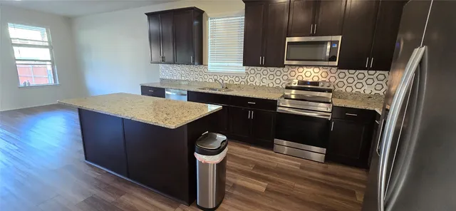 a kitchen with a sink stove and microwave