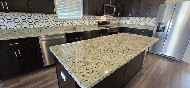 a kitchen with a sink refrigerator and microwave