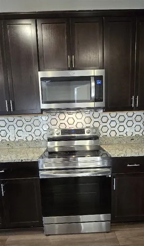 a stove top oven sitting inside of a kitchen