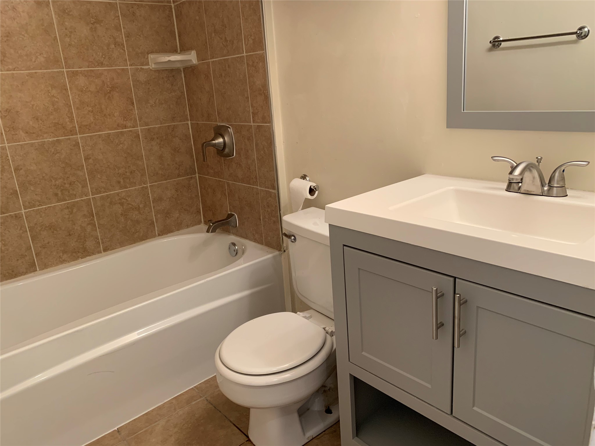 10447 Doc Holliday Trail, Unit B Austin, TX 78753 - Photo 12 of 19 Full bath with vanity, washtub / shower combination, and dark tile patterned flooring