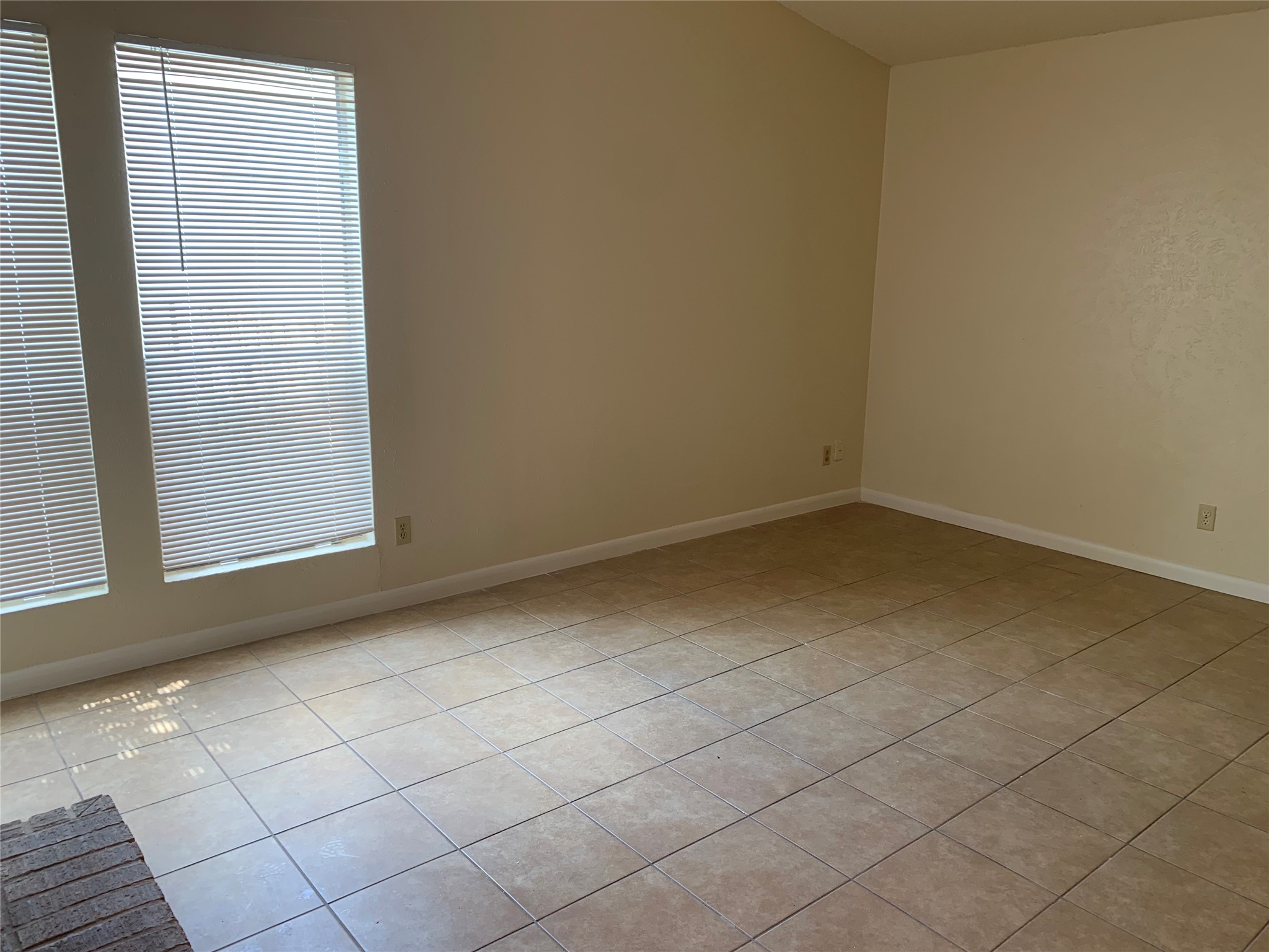 10447 Doc Holliday Trail, Unit B Austin, TX 78753 - Photo 7 of 19 Spare room with light tile patterned floors and baseboards