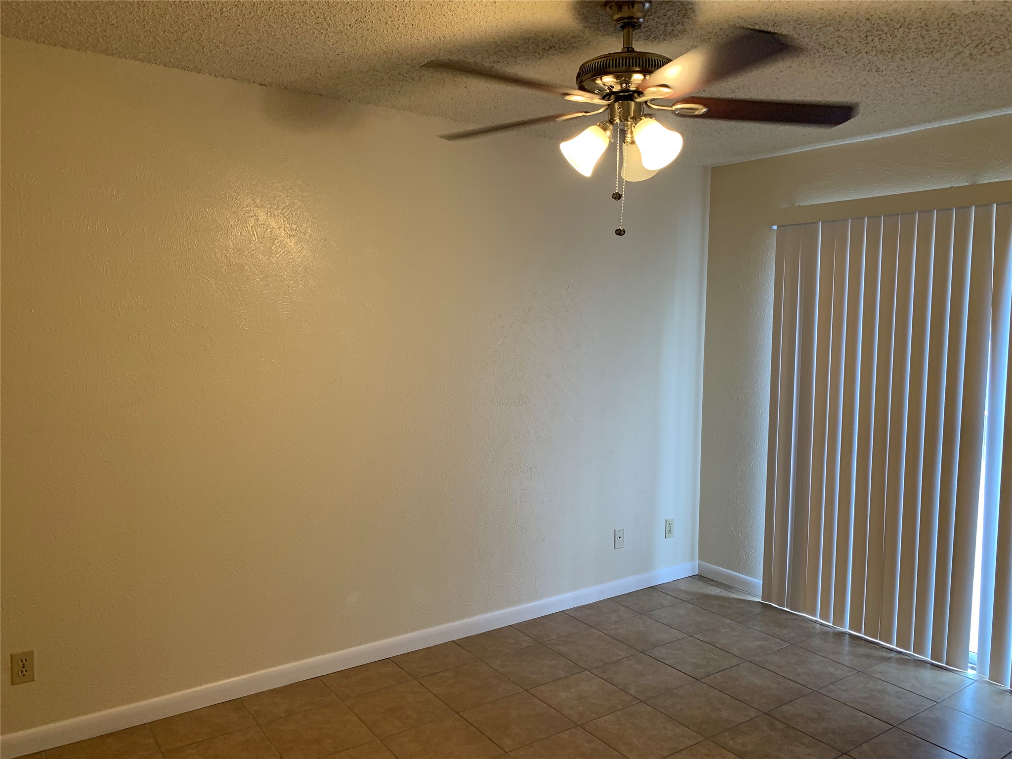 10447 Doc Holliday Trail, Unit B Austin, TX 78753 - Photo 9 of 19 Empty room with a textured ceiling and a ceiling fan