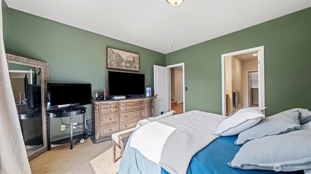 a bedroom with a bed and a flat screen tv