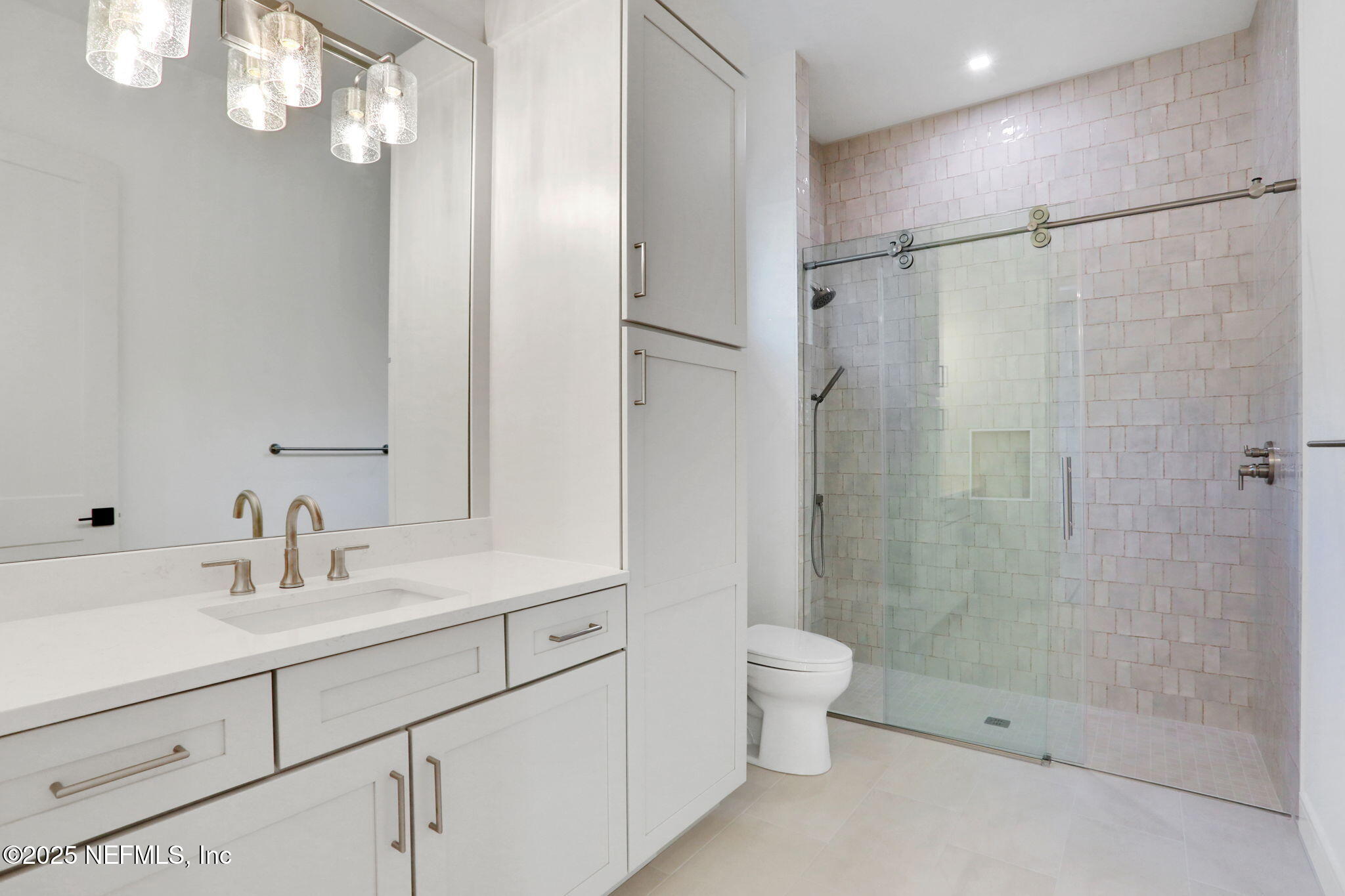 1789 North Loop Parkway St. Augustine, FL 32095 - Photo 46 of 62 a bathroom with a shower sink vanity mirror and toilet