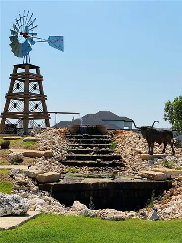 a view of a swimming pool with a lawn chairs under an umbrella