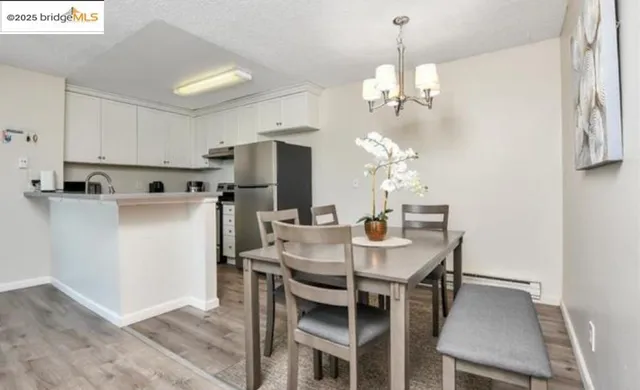 a view of a dining room with furniture and chandelier