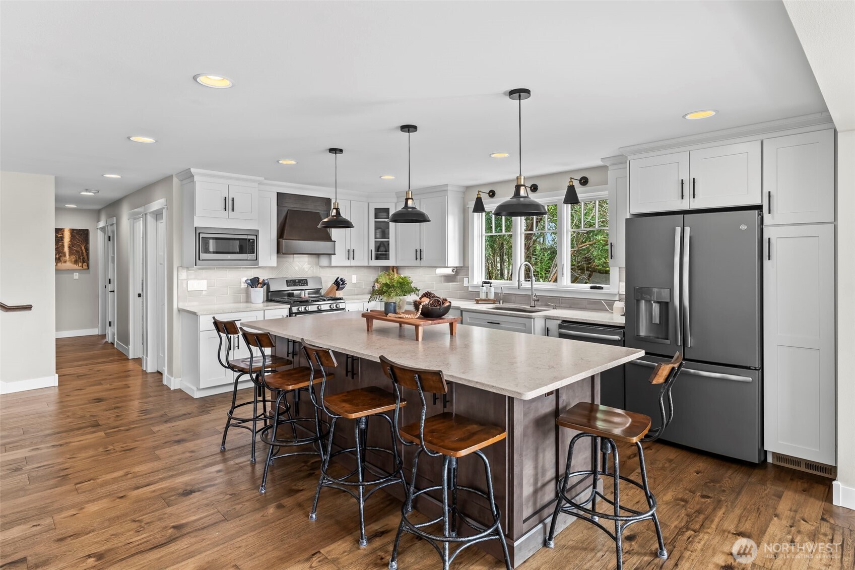 6501 27th Lane Southeast Lacey, WA 98503 - Photo 16 of 40 a kitchen with stainless steel appliances a dining table chairs refrigerator and sink