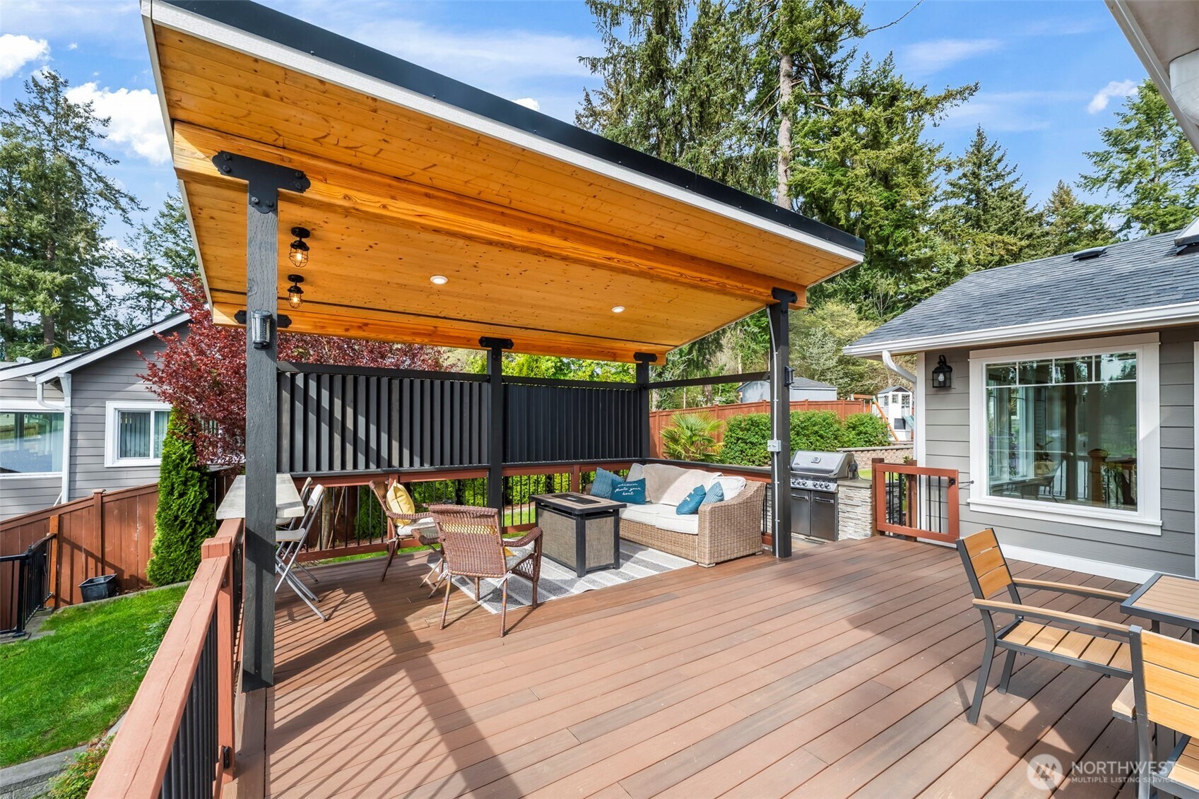 6501 27th Lane Southeast Lacey, WA 98503 - Photo 32 of 40 a view of a patio with table and chairs and wooden floor
