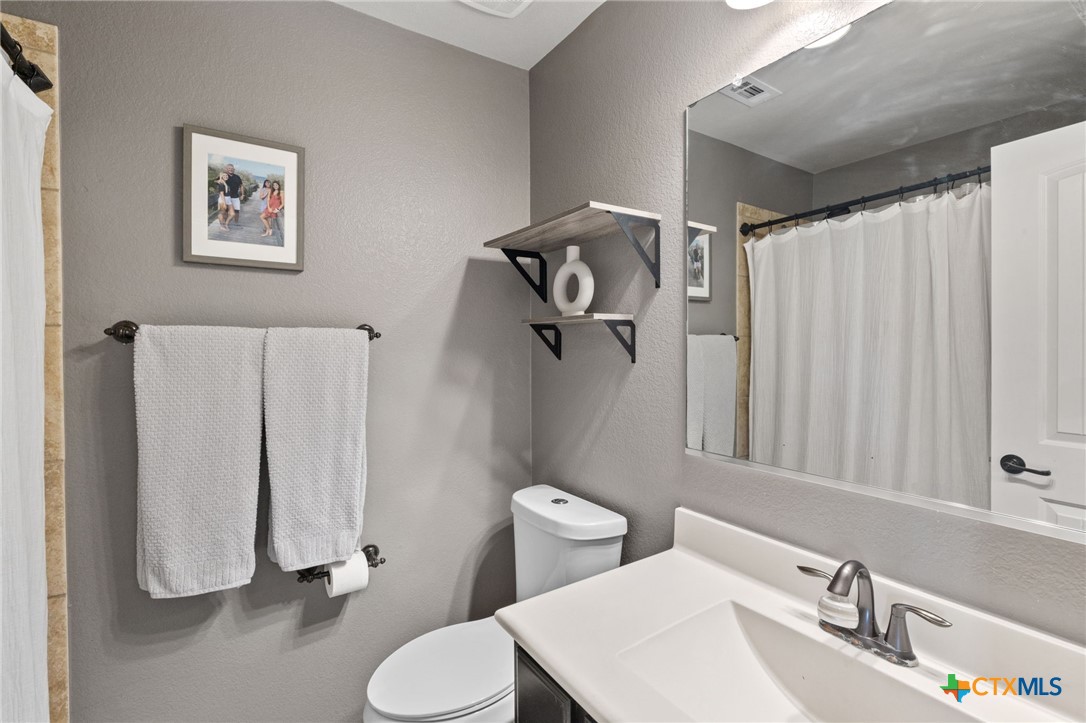 10113 Copper Ridge Cove Austin, TX 78747 - Photo 22 of 32 a bathroom with a sink toilet and shower