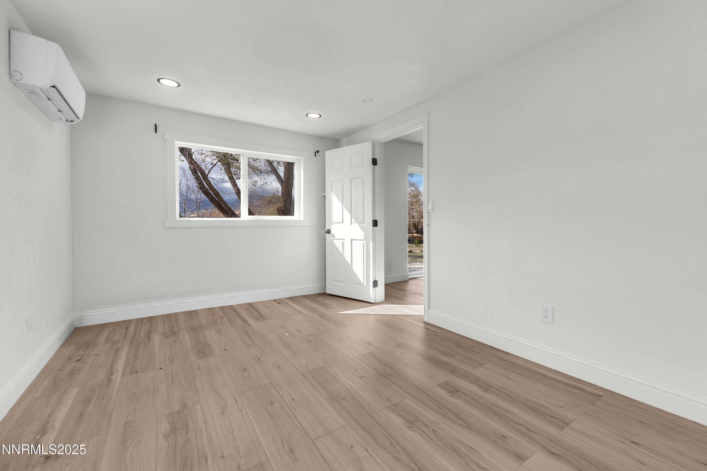 15725 Toll Road Reno, NV 89521 - Photo 19 of 27 a view of empty room with wooden floor and window