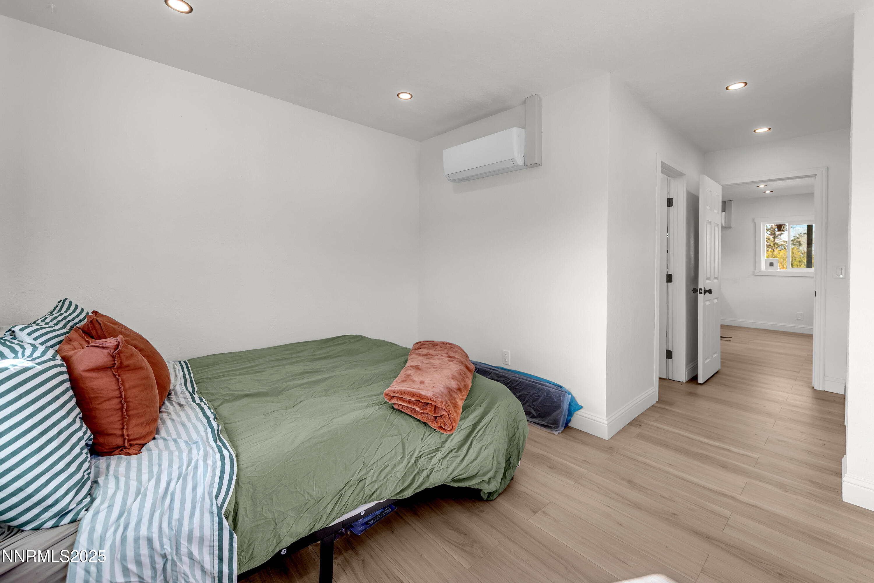 15725 Toll Road Reno, NV 89521 - Photo 21 of 27 a bedroom with a bed and a wooden floor