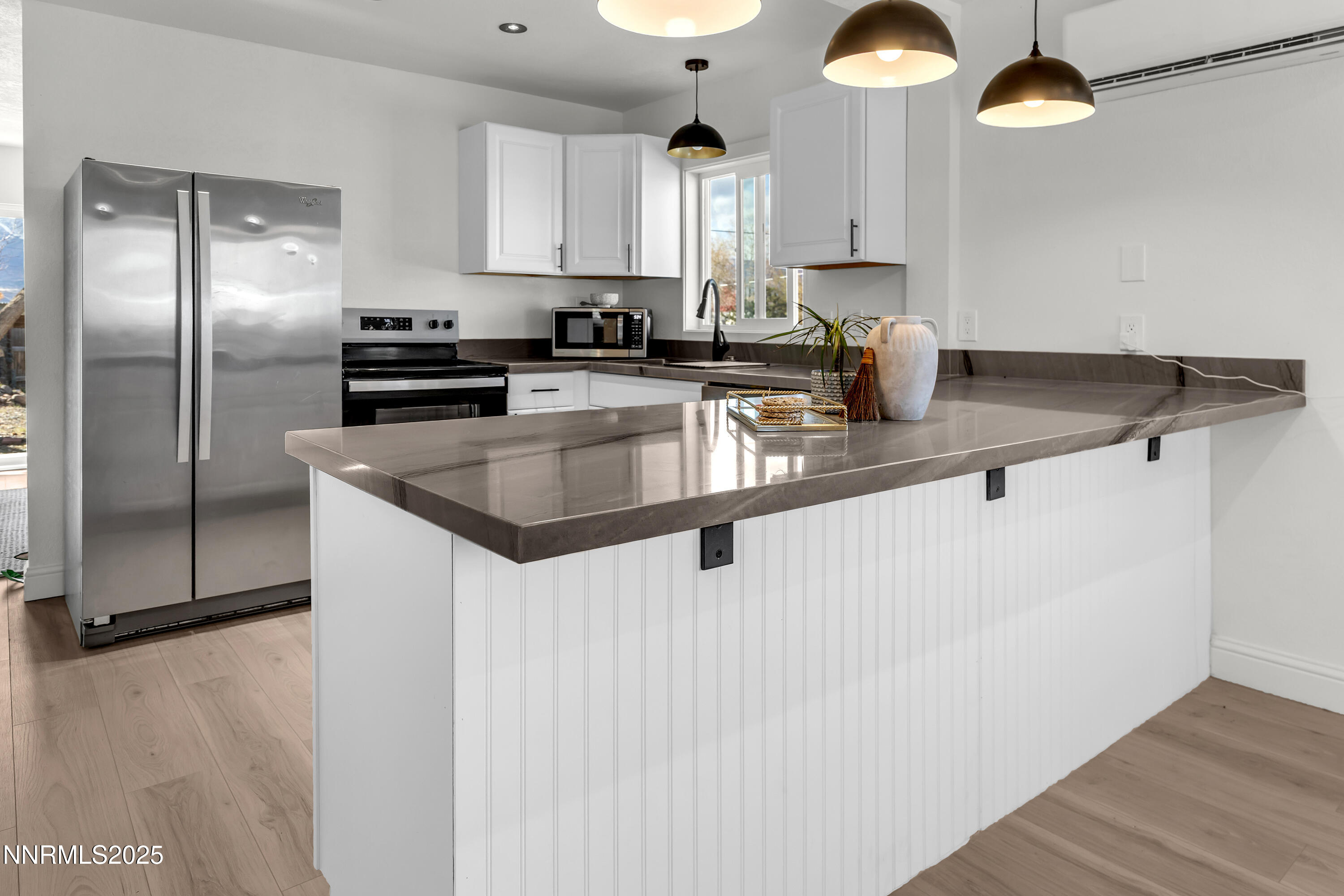 15725 Toll Road Reno, NV 89521 - Photo 7 of 27 a kitchen with stainless steel appliances granite countertop a sink a refrigerator and a stove