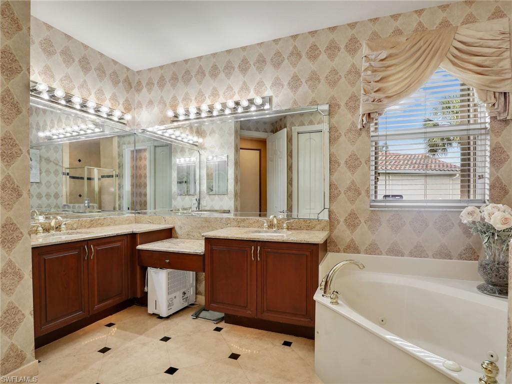 9241 Springview Loop Estero, FL 33928 - Photo 14 of 41 Full bath with vanity, a whirlpool tub, and light tile patterned flooring