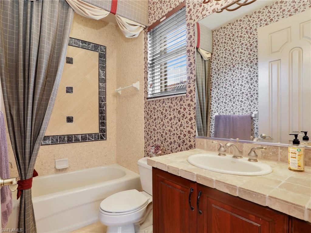 9241 Springview Loop Estero, FL 33928 - Photo 16 of 41 Bathroom with vanity and shower / bathtub combination with curtain