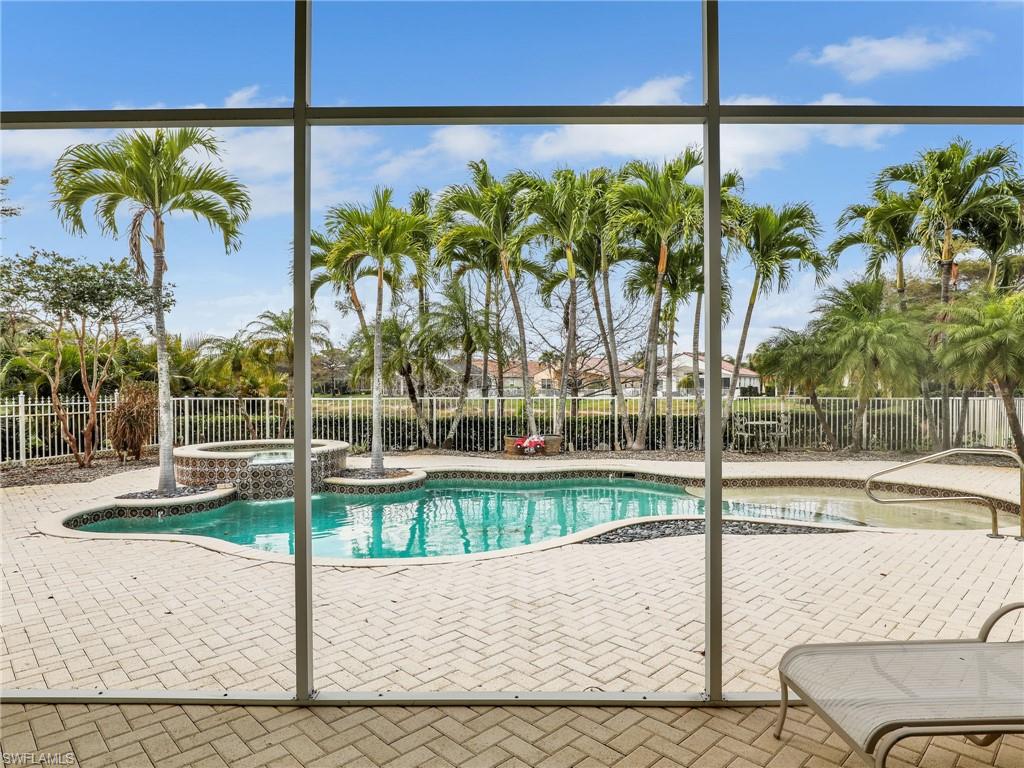 9241 Springview Loop Estero, FL 33928 - Photo 19 of 41 Integrated pool / spa with a fenced backyard, a sunroom, and a patio