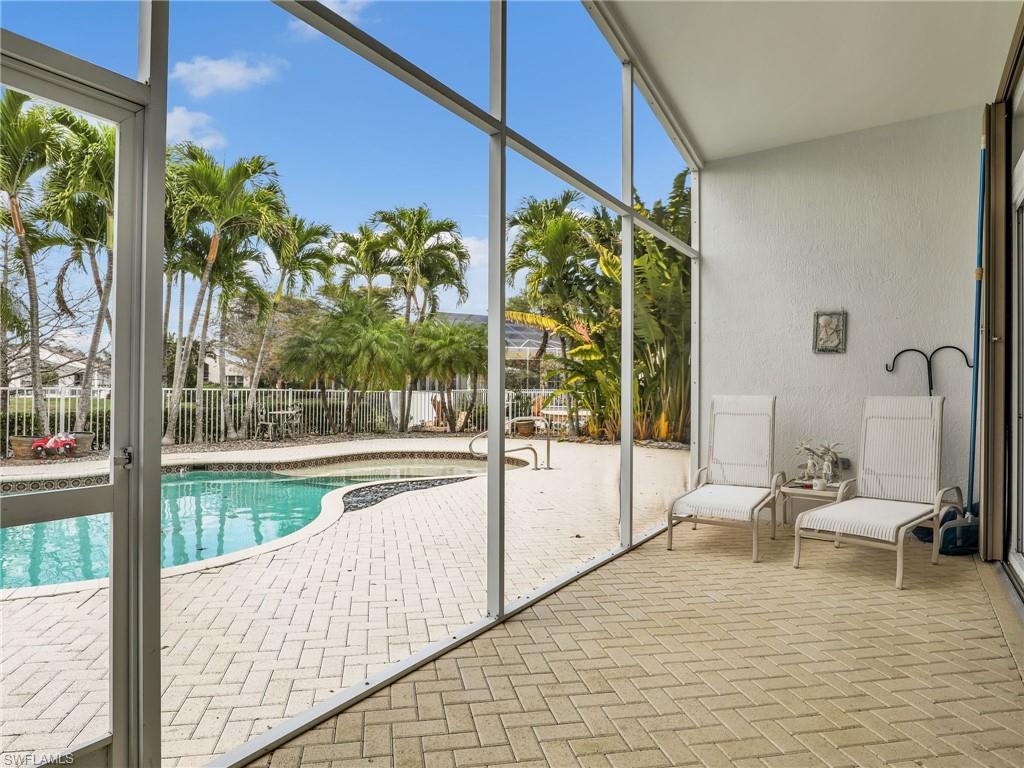 9241 Springview Loop Estero, FL 33928 - Photo 20 of 41 Combined pool / hot tub with a sunroom and a patio area