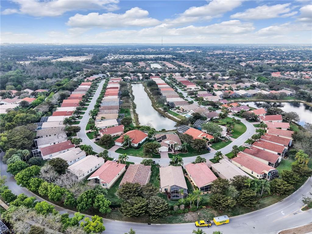 9241 Springview Loop Estero, FL 33928 - Photo 24 of 41 Aerial overview of property's location with a nearby body of water and nearby suburban area