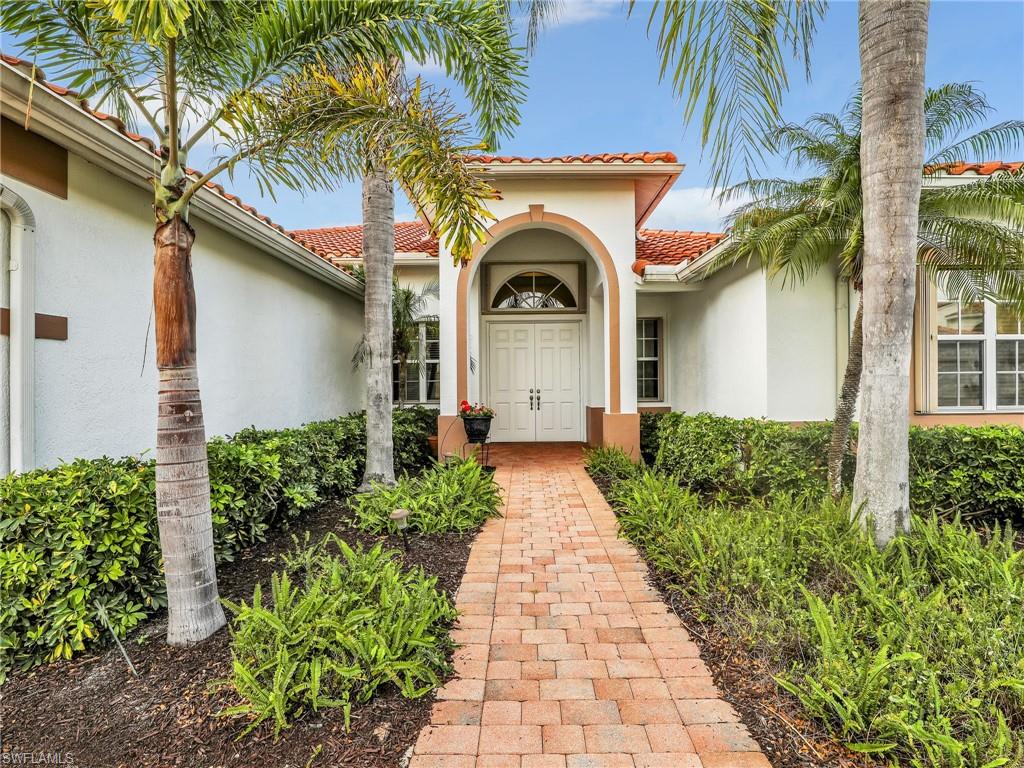 9241 Springview Loop Estero, FL 33928 - Photo 38 of 41 Doorway to property featuring stucco siding and a tile roof