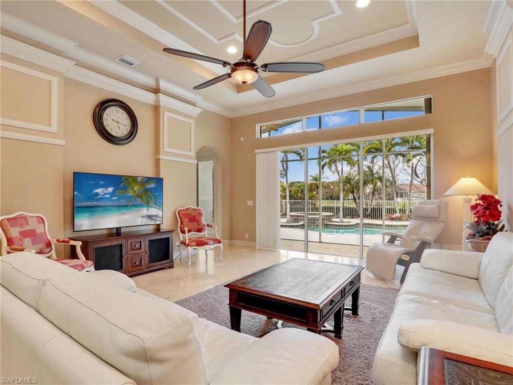 9241 Springview Loop Estero, FL 33928 - Photo 5 of 41 Living area with ceiling fan, ornamental molding, a high ceiling, recessed lighting, and arched walkways