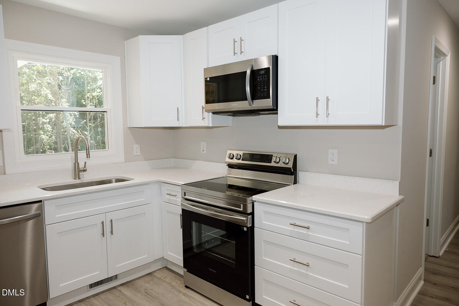 291 Knight Road Broadway, NC 27505 - Photo 6 of 18 a kitchen with white cabinets and a stove top oven