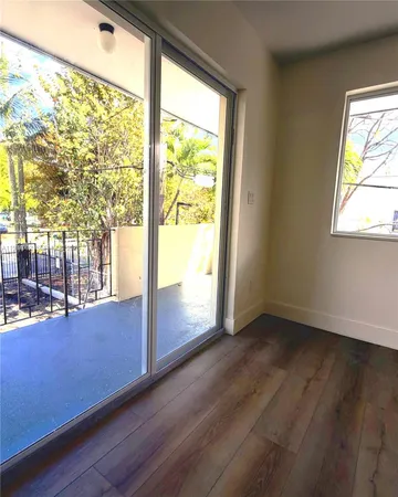 a view of a hallway view with wooden floor and living room